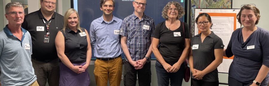 Happy Action Read Board members posing for a photo in front of a screen.