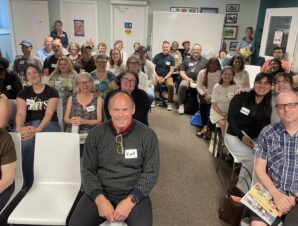 Group shot of Action Read members sitting and listening to the AGM announcements.